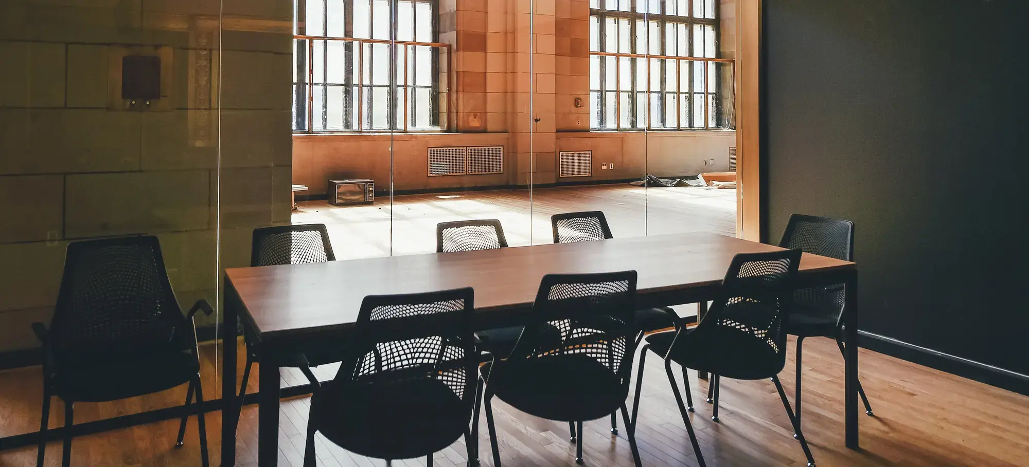 A small conference room with a long table and chairs