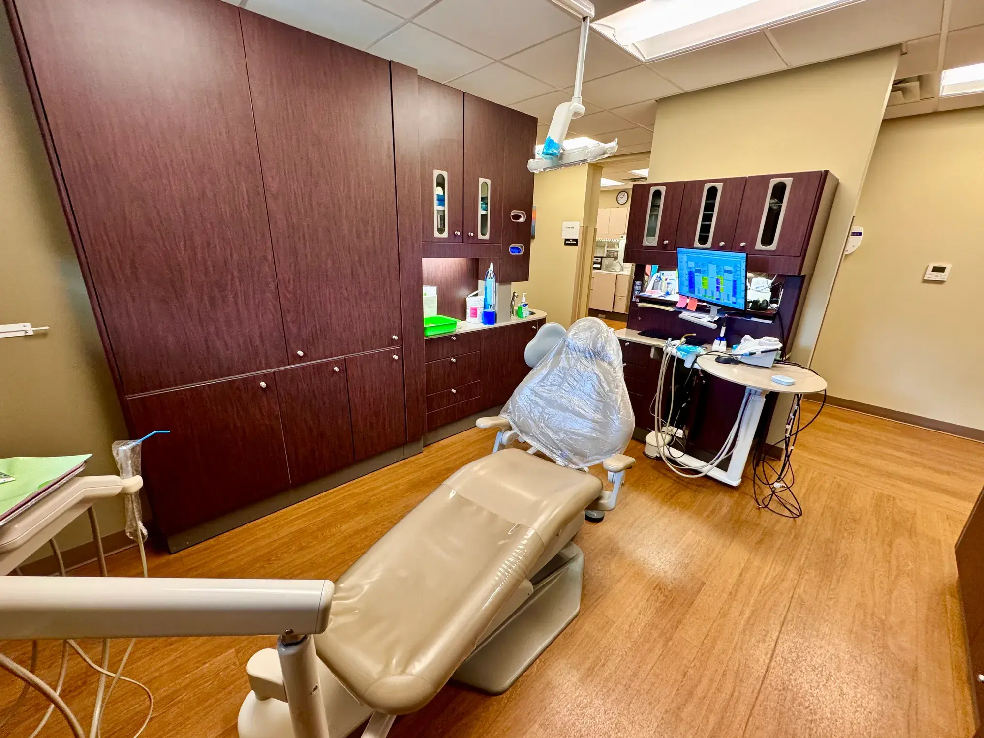 A dental chair and equipment in a treatment room