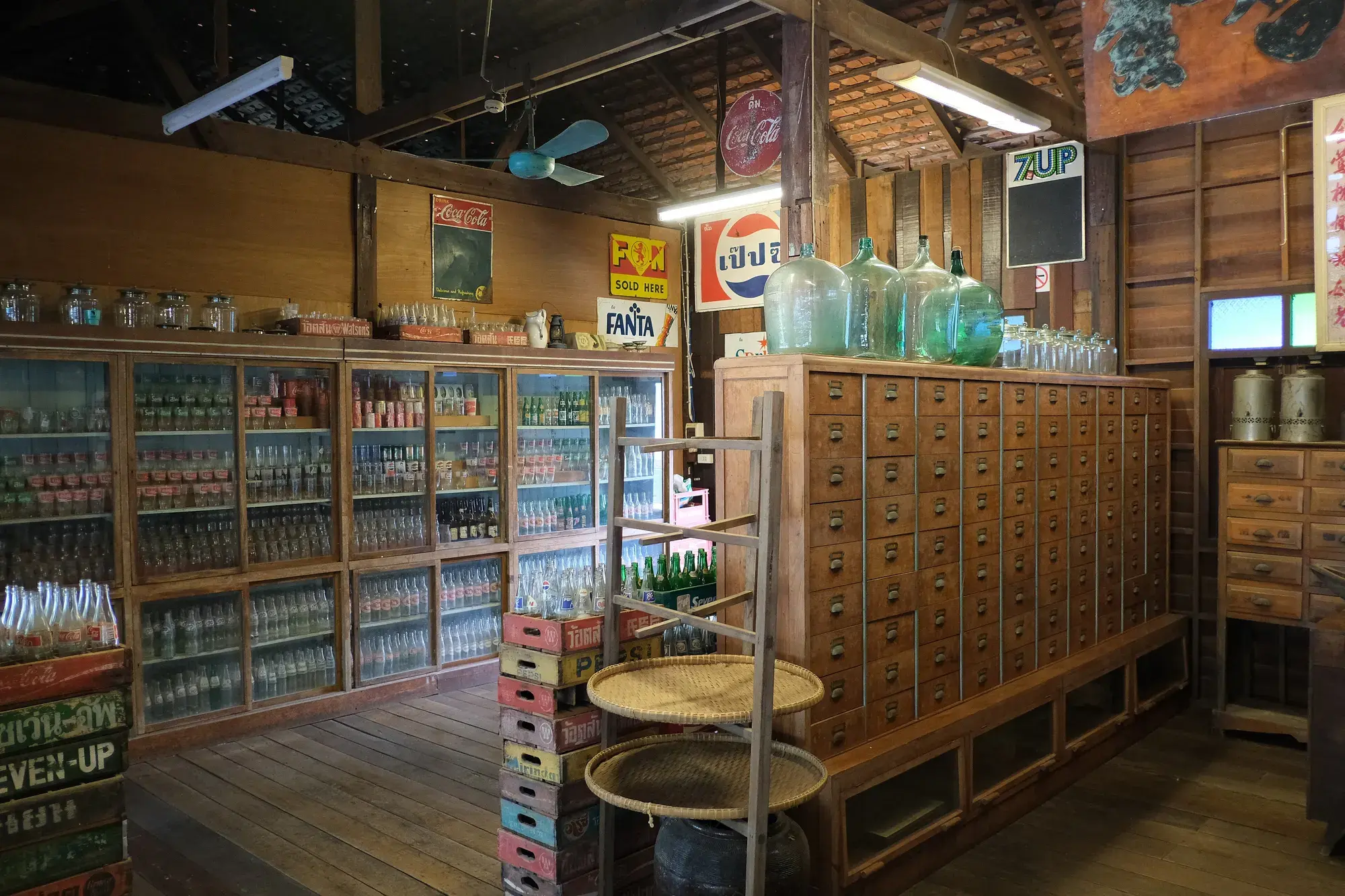 The interior of a small shop lined with shelves of goods