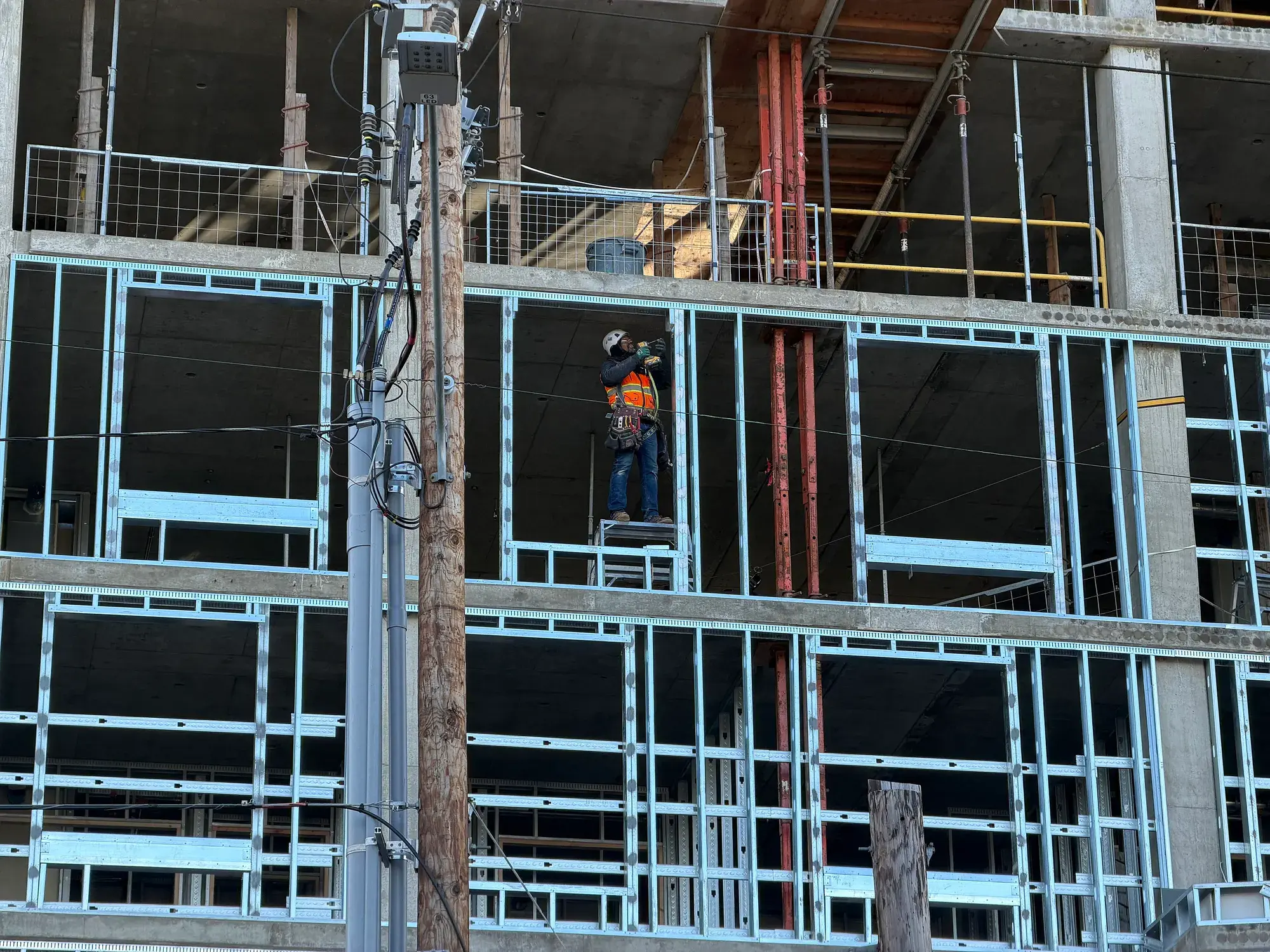 A construction worker on the steel framing of a building